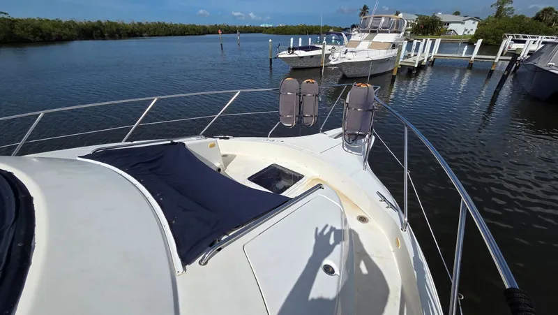 Slide: The Image of 2001 Silverton 453 yacht docked with calm waters. - 9