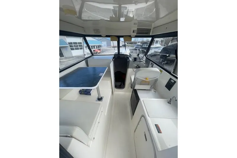 Slide: The Image of Interior of a 2006 Trophy 2359 Hardtop boat with seating and navigation area. - 13
