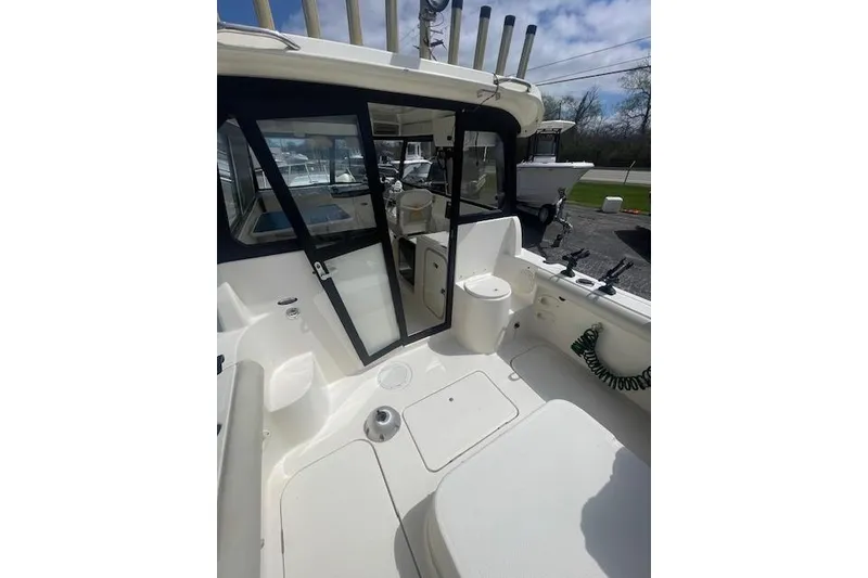 Slide: The Image of 2006 Trophy 2359 Hardtop boat interior with seating and fishing rod holders. - 14