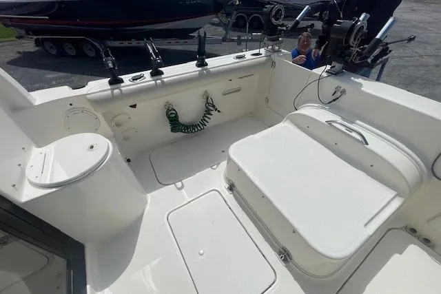 Slide: The Image of 2006 Trophy 2359 Hardtop boat interior with fishing rod holders and seating area. - 15