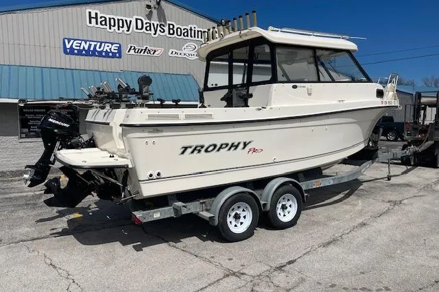Slide: The Image of 2006 Trophy 2359 Hardtop boat on trailer at Happy Days Boating, sunny day. - 2