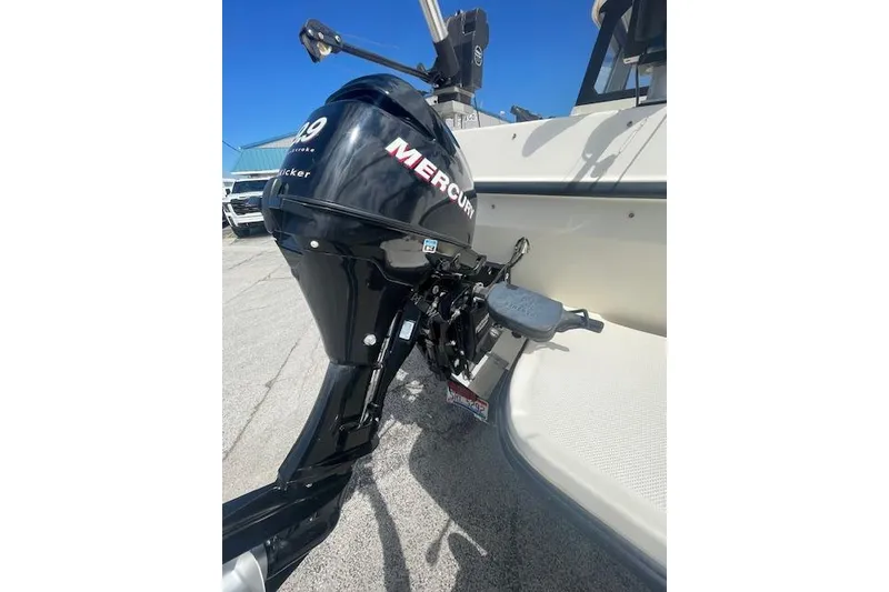 Slide: The Image of 2006 Trophy 2359 Hardtop boat with Mercury outboard motor, docked on a sunny day. - 20