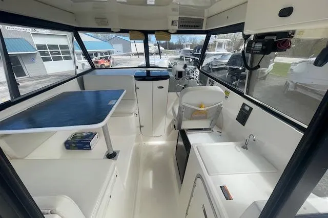 Slide: The Image of Interior of a 2006 Trophy 2359 Hardtop boat with seating and navigation area. - 9