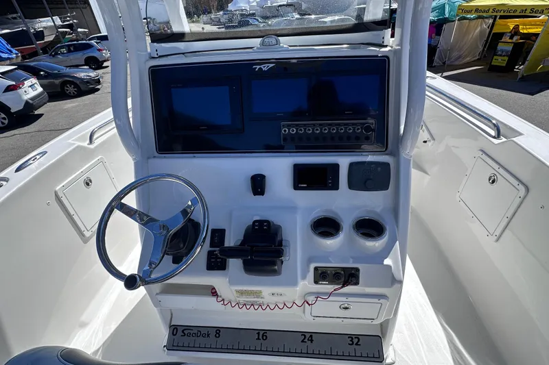 Slide: The Image of 2017 Tidewater 252 CC Adventure boat console with steering wheel and navigation controls. - 10