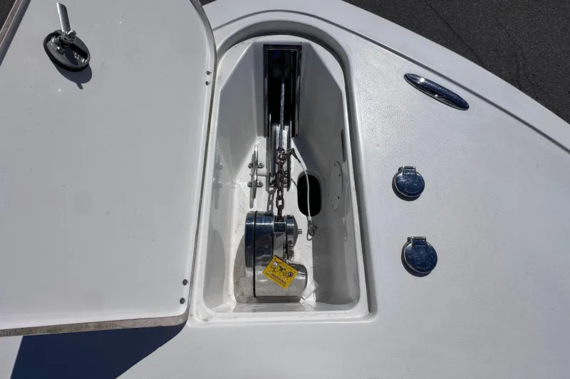 Slide: The Image of Anchor compartment of 2017 Tidewater 252 CC Adventure boat, featuring chain and winch. - 15