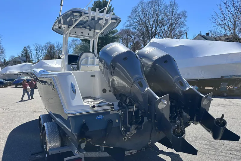 Slide: The Image of 2017 Tidewater 252 CC Adventure boat with dual outboard motors on a trailer. - 4