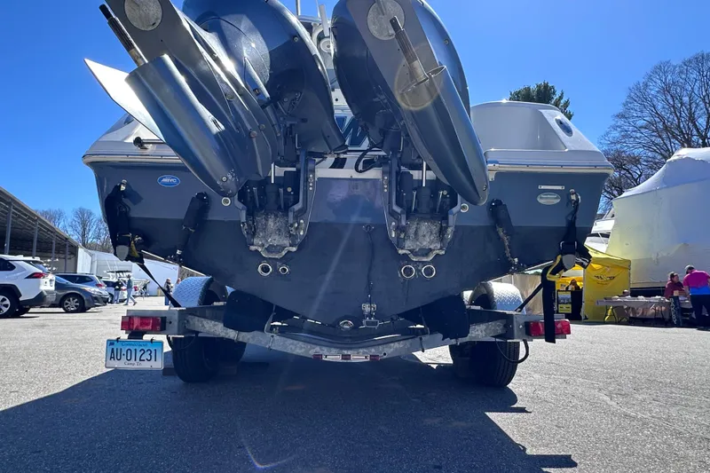 Slide: The Image of 2017 Tidewater 252 CC Adventure boat on trailer, rear view with dual engines. - 5