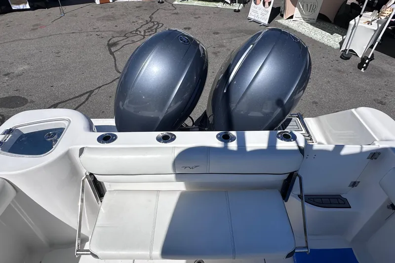 Slide: The Image of 2017 Tidewater 252 CC Adventure boat with dual outboard motors and seating area. - 7