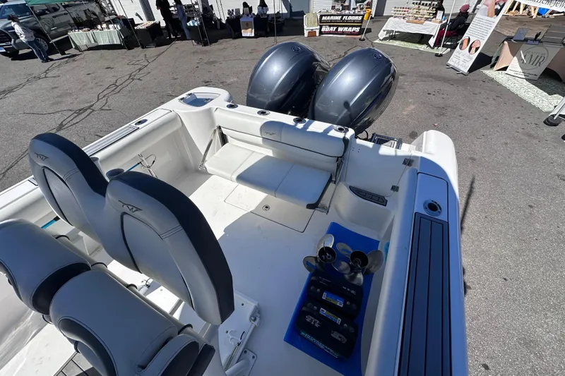 Slide: The Image of 2017 Tidewater 252 CC Adventure boat with dual engines, showcased at an outdoor event. - 8