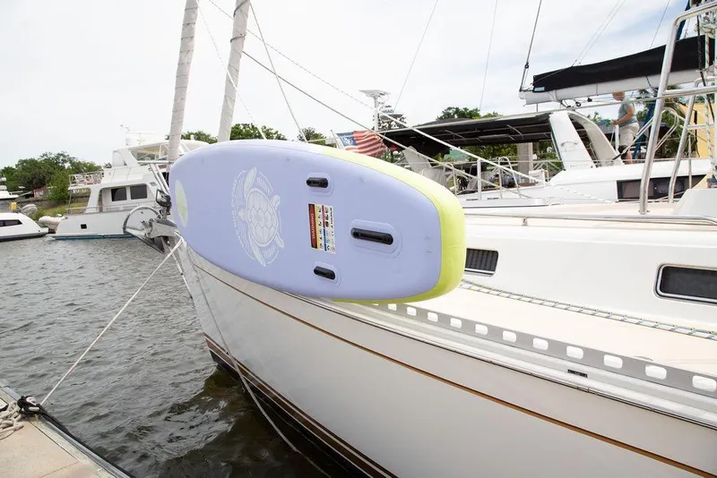 Slide: The Image of Sailboat docked with paddleboard attached, Outbound 46 model, 2015. - 101