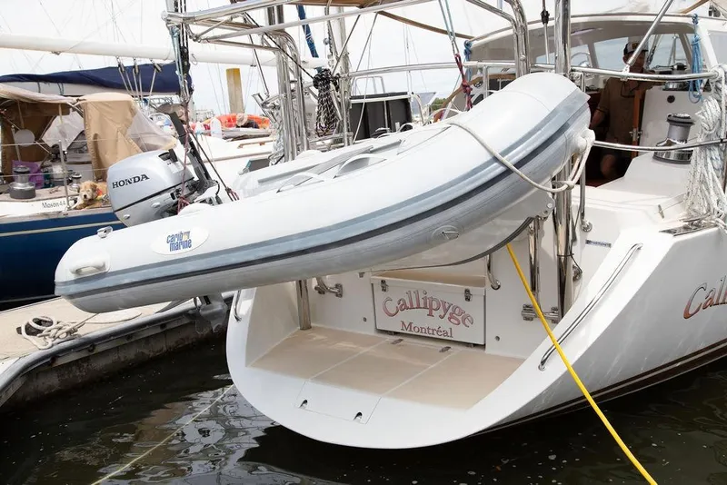 Slide: The Image of Sailboat "Callipyge" with dinghy, Outbound 46, 2015 model, docked in a marina. - 102