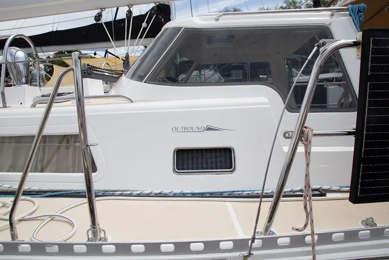 Slide: The Image of 2015 Outbound 46 sailboat with sleek white exterior and stainless steel railings. - 14