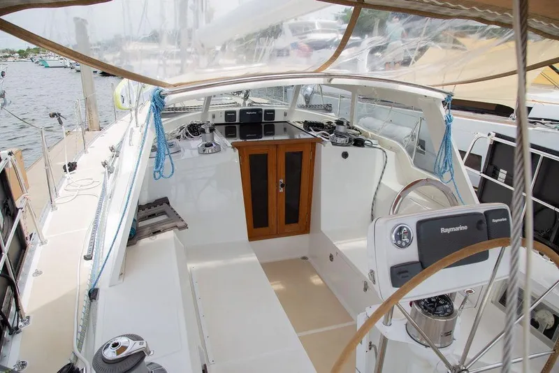 Slide: The Image of Cockpit of 2015 Outbound 46 sailboat with navigation equipment and wooden cabinetry. - 15