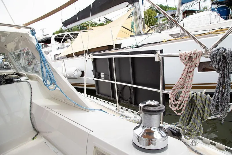 Slide: The Image of Sailboat deck with ropes and winch, Outbound 46, 2015 model, docked at marina. - 17