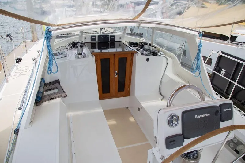 Slide: The Image of Cockpit of 2015 Outbound 46 sailboat with Raymarine navigation system and wooden accents. - 18