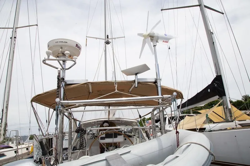 Slide: The Image of Sailboat Outbound 46 (2015) with radar and wind turbine at marina. - 21