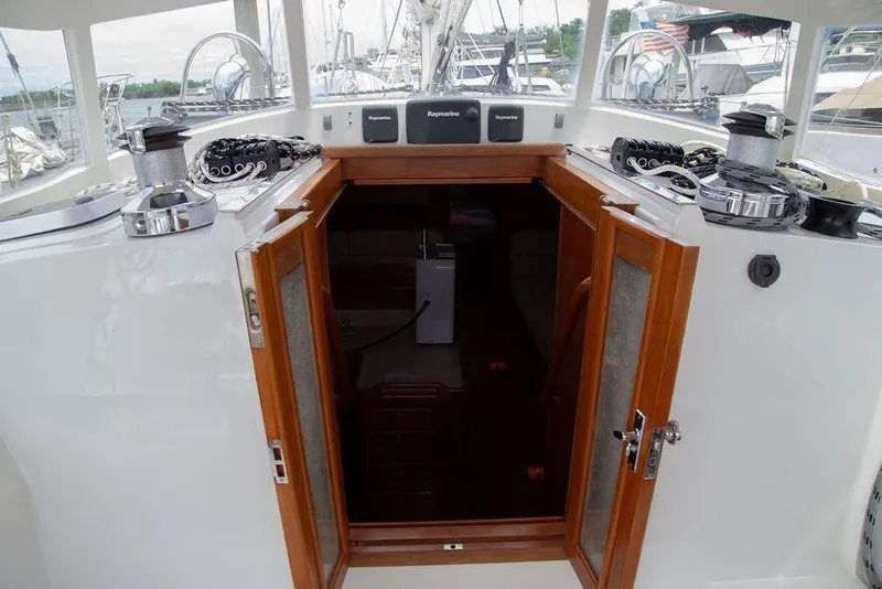 Slide: The Image of Cockpit entrance of 2015 Outbound 46 yacht with open wooden doors. - 29