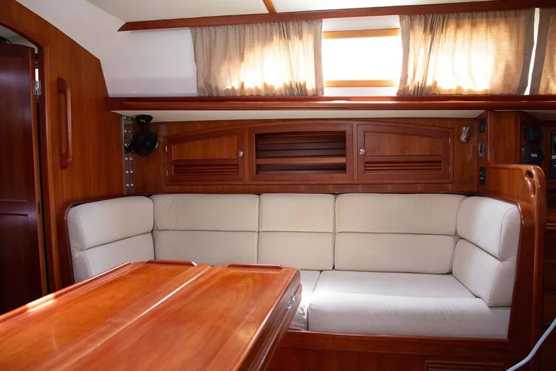 Slide: The Image of Interior of 2015 Outbound 46 yacht with wooden finish and beige seating. - 34