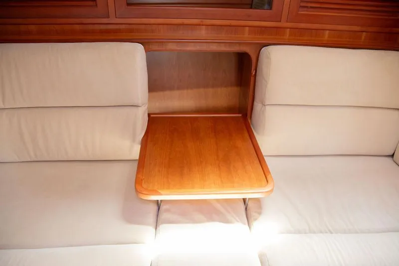 Slide: The Image of Interior of 2015 Outbound 46 yacht with wooden table and beige seating. - 35