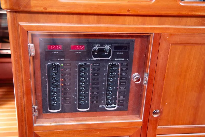 Slide: The Image of Electrical panel of a 2015 Outbound 46 yacht, featuring AC and DC systems. - 42