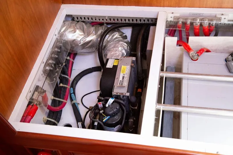 Slide: The Image of Electrical compartment of a 2015 Outbound 46 yacht, featuring wiring and components. - 45