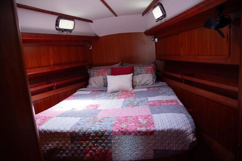 Slide: The Image of Cozy cabin bedroom with patchwork quilt on Outbound 46 yacht, 2015 model. - 48