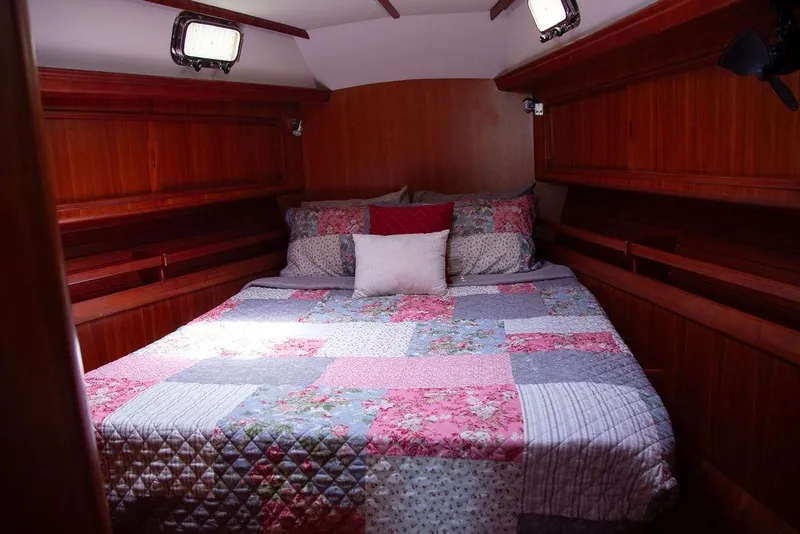 Slide: The Image of Cozy cabin bedroom with patchwork quilt on Outbound 46 yacht, 2015 model. - 49