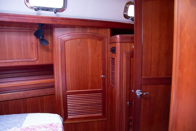 Slide: The Image of Interior of 2015 Outbound 46 yacht with wooden cabinetry and portholes. - 52