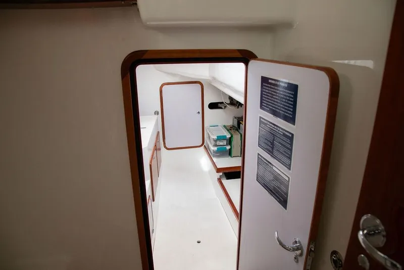 Slide: The Image of Interior view of 2015 Outbound 46 yacht, featuring sleek white cabinetry and wooden trim. - 63