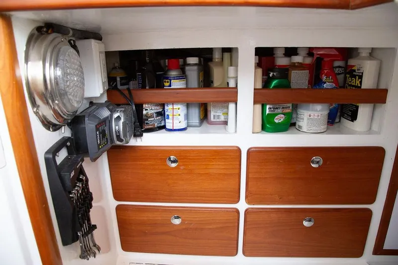 Slide: The Image of Storage area on a 2015 Outbound 46 yacht with cleaning supplies and tools. - 66