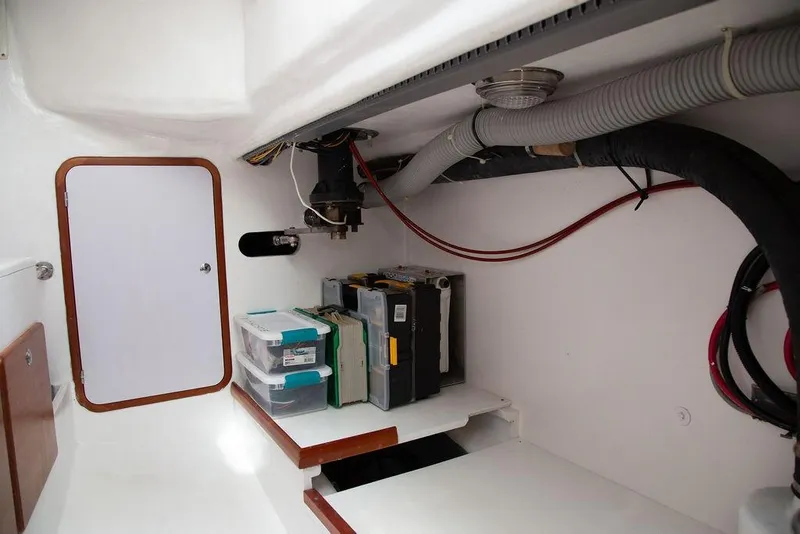 Slide: The Image of Engine compartment of 2015 Outbound 46 yacht with storage and wiring. - 70