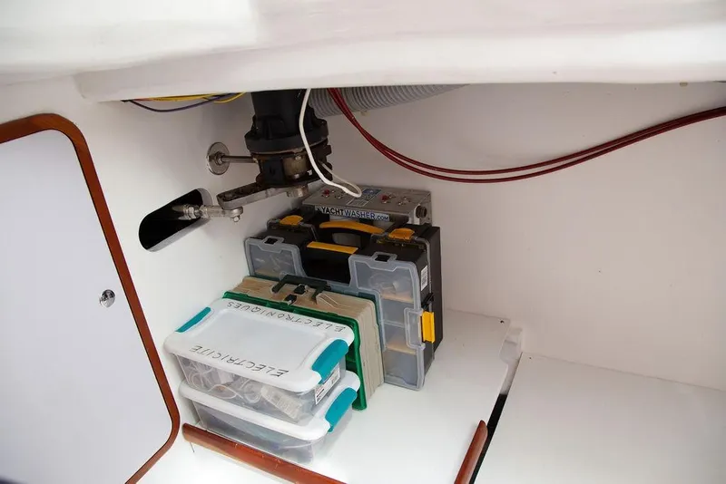 Slide: The Image of Storage compartment in a 2015 Outbound 46 yacht with organized electrical supplies. - 72