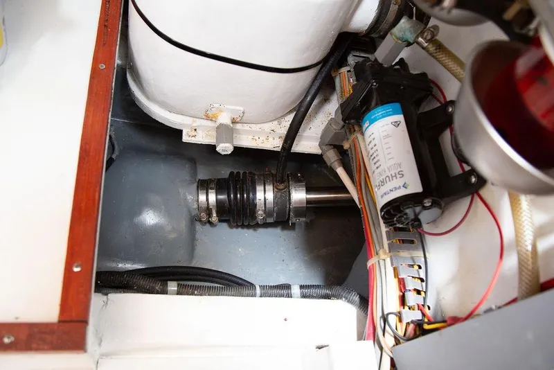 Slide: The Image of Engine compartment of a 2015 Outbound 46 yacht, featuring mechanical components and wiring. - 73
