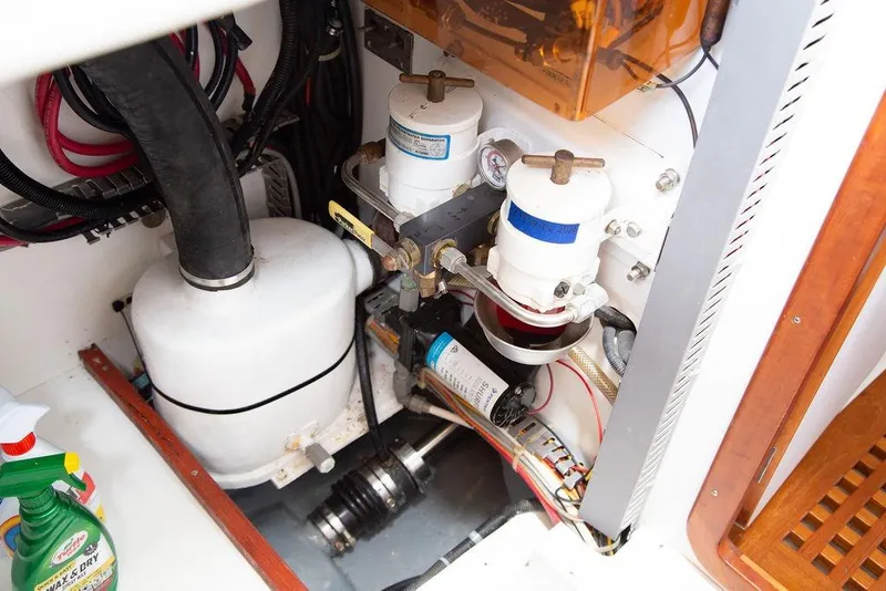 Slide: The Image of Engine compartment of a 2015 Outbound 46 yacht, featuring filters and wiring. - 74