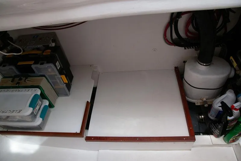 Slide: The Image of Storage compartment in a 2015 Outbound 46 yacht with organized tools and supplies. - 75