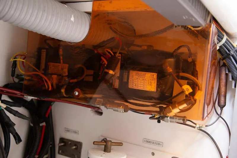 Slide: The Image of Engine compartment of 2015 Outbound 46 yacht with visible wiring and components. - 76