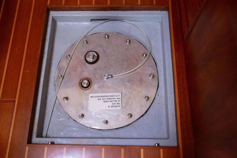 Slide: The Image of Fuel tank access panel on 2015 Outbound 46 yacht, wooden floor surrounding. - 78