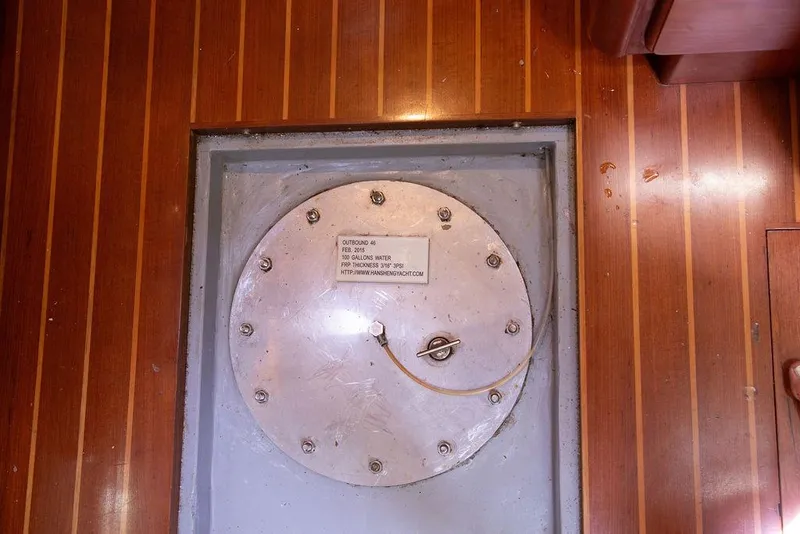 Slide: The Image of Circular metal hatch on wooden floor of 2015 Outbound 46 yacht. - 80