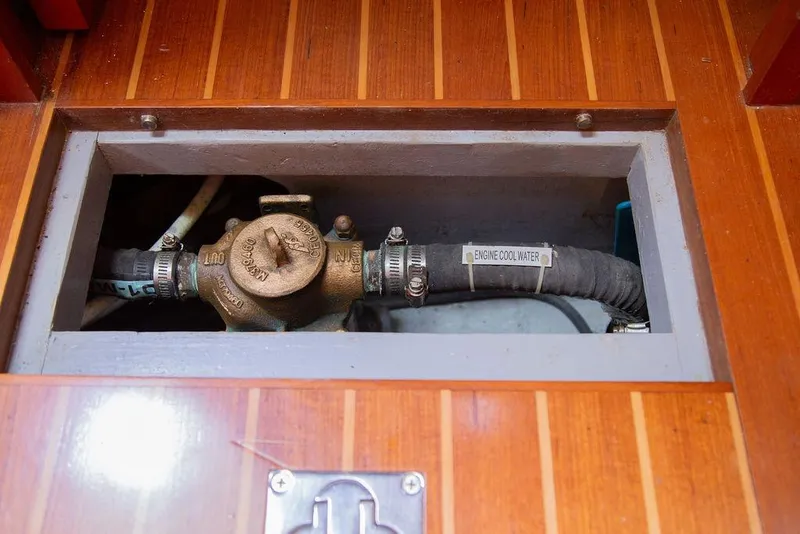 Slide: The Image of Engine cooling system in 2015 Outbound 46 yacht, featuring labeled hoses and fittings. - 83