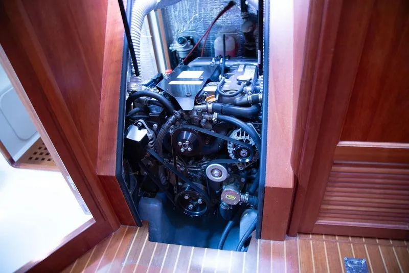 Slide: The Image of Engine compartment of a 2015 Outbound 46 yacht, showcasing mechanical components. - 86