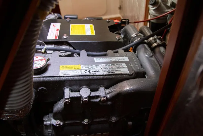 Slide: The Image of Engine compartment of a 2015 Outbound 46 yacht, featuring detailed mechanical components. - 87