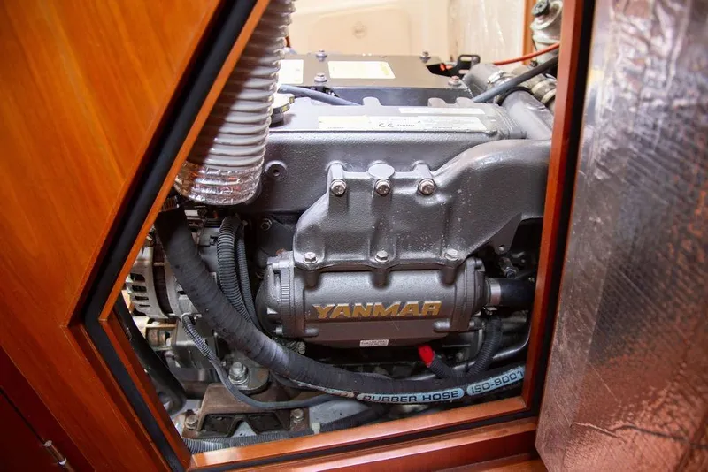 Slide: The Image of Engine compartment of a 2015 Outbound 46 sailboat featuring a Yanmar engine. - 88