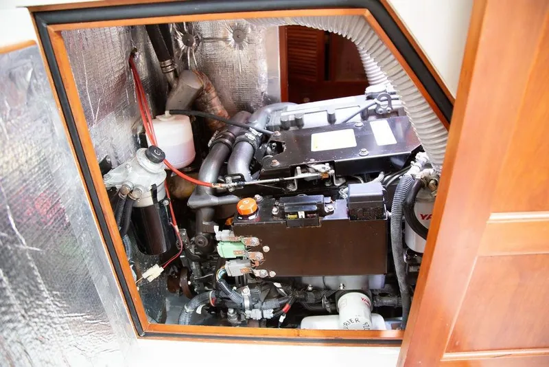 Slide: The Image of Engine compartment of a 2015 Outbound 46 yacht, showcasing mechanical components and wiring. - 89