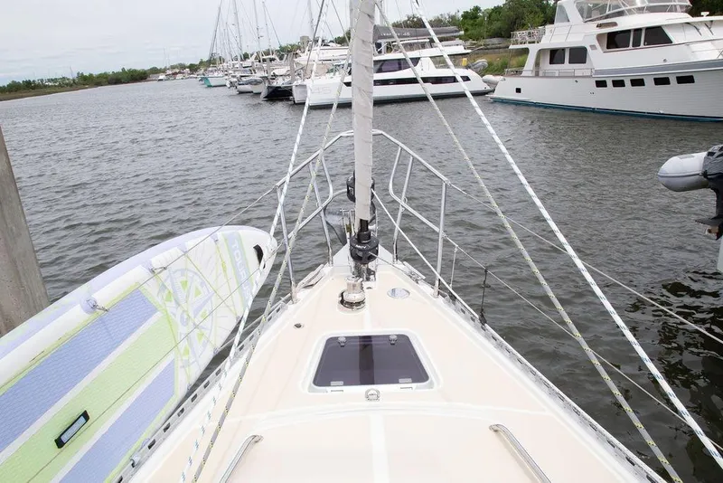 Slide: The Image of Bow view of 2015 Outbound 46 sailboat docked with paddleboard. - 9