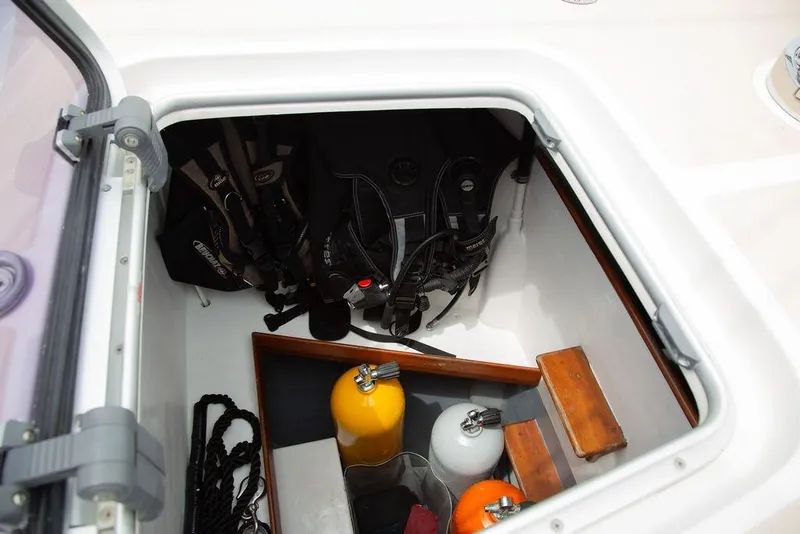 Slide: The Image of Storage compartment on 2015 Outbound 46 yacht with scuba gear and tanks. - 91
