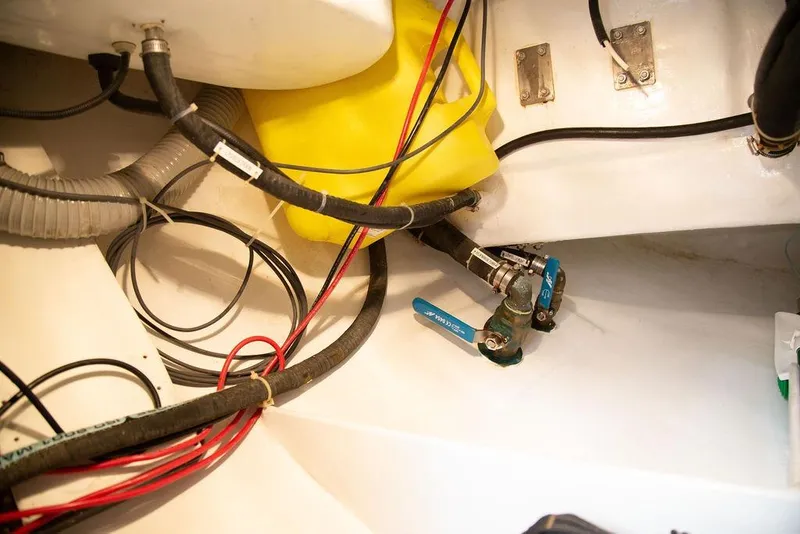 Slide: The Image of Engine room of 2015 Outbound 46 yacht with hoses and valves. - 92