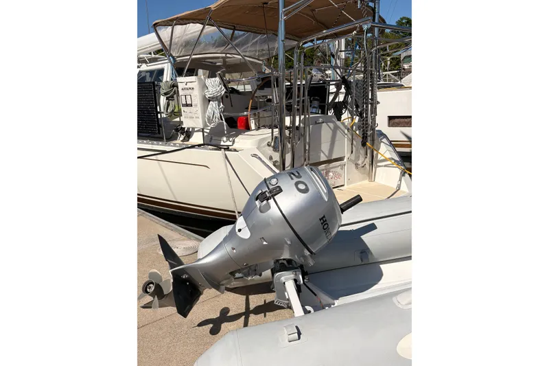 Slide: The Image of 2015 Outbound 46 yacht with Honda outboard motor at dock. - 94