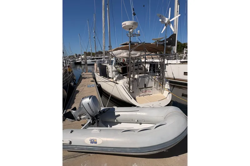 Slide: The Image of Sailboat docked with inflatable dinghy, Outbound 46 model, 2015. - 97