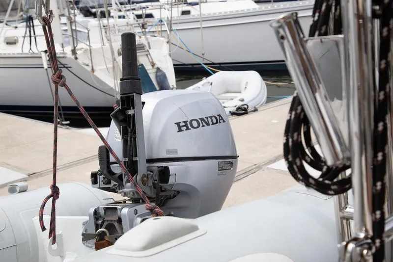 Slide: The Image of Honda outboard motor on a 2015 Outbound 46 sailboat at a marina. - 98
