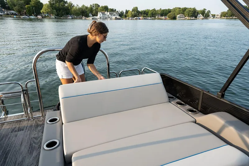 The Image of Manufacturer Provided Image: Woman on Qwest Splash Pad E-Class 2025 boat by the lake. - 0